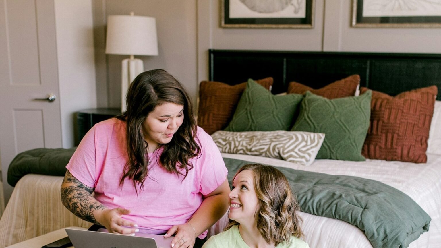 Two people comparing SEO proposals on a laptop before choosing an affordable SEO service provider